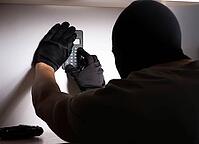 The burglar with a balaclava at the crime scene [IBR113372468]