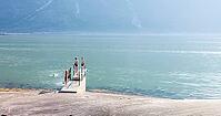 Kids swimming and jumping in cool fjord water, having fun, Eidfjord, Norway [IBR113372473]