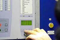 The operator presses the button to control the parameters of the LNG compressor unit with his hand [IBR125363548]