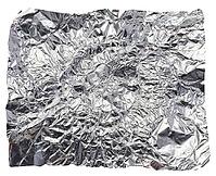 Crumpled piece of gray foil on a white isolated background, close up [IBR125363627]