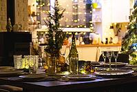 Festive interior of house is decorated for Christmas and New Year in loft style with black stove, fireplace, Christmas tree. Warm studio room with set table, burning wood, cozy and heating of home [IBR125382566]