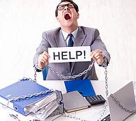Busy employee is chained to his desk [IBR125382590]