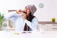 Young man suffers from flu at home [IBR125382602]