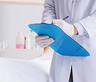 Police coroner examines body in morgue [IBR125382607]
