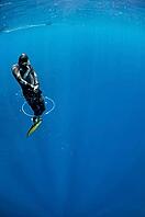 Freediver tries to swim through the bubble air ring at the depth of Blue Hole, Dahab, Egypt [IBR125382609]