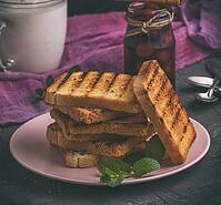 Fried square pieces of white wheat flour in a ceramic pink plate, vintage toning [IBR125382622]