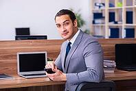 Male employee working in office [IBR125382624]
