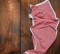 Red kitchen towel on brown wooden background, top view, copy space [IBR125382630]