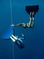 One freediver stops his movement while other controls friend's behaviour [IBR125382633]