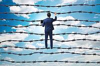 Businessman in barbed wire concept [IBR125382636]