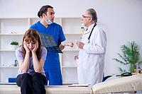 The two doctors examine young woman [IBR125382643]