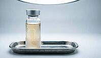 Clear cryogenic vial with pale DNA reference sample, condensation, stainless steel tray, clinical studio lighting, studio shot, AI generated [IBR125395919]