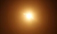 Front-facing texture of high noon sunlight glow, bright central luminance fading evenly outward, no visible source object. AI generated [IBR125395947]