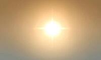 Front-facing texture of high noon sunlight glow, bright central luminance fading evenly outward, no visible source object. AI generated [IBR125395948]