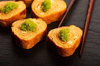 Japanese Tamagoyaki with Green Wasabi Caviar on Black Stone Board [IBR125405036]
