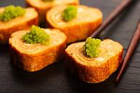 Japanese Tamagoyaki with Green Wasabi Caviar on Black Stone Board [IBR125405061]