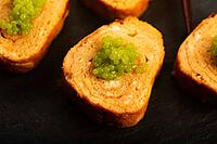 Japanese Tamagoyaki with Green Wasabi Caviar on Black Stone Board [IBR125405069]