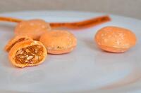 Close-up of the traditional Négus de Nevers, a regional confection made from caramel with almonds and a shiny orange-brown sugar glaze on a white plate, Nevers, department of Nievre, Bourgogne-Franche-Comte, France [IBR125405075]