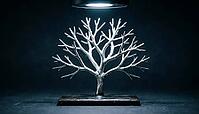 Close-up of a branching tree-like metallic lithium dendrite filament splitting into secondary branches on dark ceramic substrate, charcoal background, battery failure science, AI generated [IBR125407397]