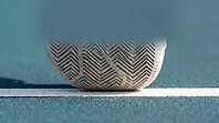 Close-up of a white tennis shoe's herringbone tread sole pressed against a hard court surface along a painted white baseline, bright natural daylight, sports footwork concept, AI generated [IBR125407438]