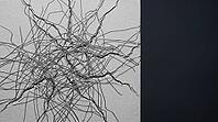Interlocking network of metallic lithium dendrite filaments and crack lines on ceramic block surface, dark background, clinical lighting, studio shot, AI generated [IBR125407473]