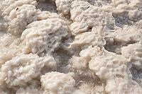Close-up of naturally crystallized salt on the ground on the shore of a salt lake [IBR125411086]