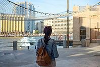 A young traveler is walking and enjoying the old narrow streets of Dubai Deira and Creek. Travel and sightseeing concept [IBR125411090]