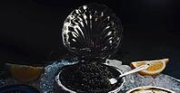 Black caviar served on the table. Exquisite delicacy of black sturgeon caviar [IBR125411145]