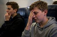 Adolescent passengers experience flight anxiety and motion sickness inside an airplane cabin during transit, travel fatigue and acute headache, youthful vulnerability during air travel, confined cabin space generating mental exhaustion and sensory oversti [IBR125414139]