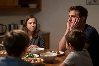 Exhausted parents face emotional burnout at family dinner table, domestic tension and psychological stress challenge young household dynamics, father resting chin in hands reveals mental fatigue and overwhelming parental responsibility, mother observing q [IBR125414169]
