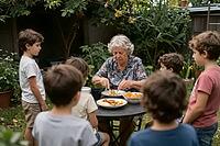 Intergenerational care and familial nutrition, grandmother serving fresh food to young grandchildren in a green garden, attentive boys waiting for lunch, domestic kinship and communal outdoor dining, healthy meal with fruits and vegetables, nurturing mate [IBR125414174]
