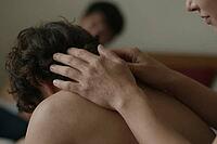 Tactile bodywork, manual therapy, somatic relaxation, gentle hands touching tense neck muscles, physical closeness, human connection, empathy, soothing touch of palms on bare skin for myofascial release, osteopathic tension relief and psychological ground [IBR125414202]