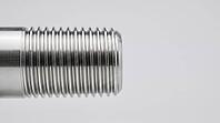 Close-up of a freshly machined steel pipe threaded end with crisp trapezoidal thread grooves on pale grey studio background, precision engineering, industrial macro photography, AI generated [IBR125414205]