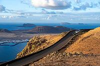 Road on the coast, back island of La Graciosa, Mirador del Porrito viewpoint at sunset, Lanzarote, Canary Islands, Spain [IBR125414218]