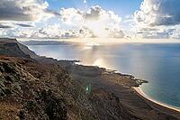 Steep cliffs on the coast with sea, Mirador del Porrito viewpoint at sunset, Lanzarote, Canary Islands, Spain [IBR125414219]