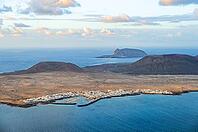 View of the sea and the island of La Graciosa with the village of Caleta de Sebo, at sunset, Lanzarote, Canary Islands, Spain [IBR125414220]