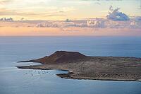 View of the sea and the island of La Graciosa with the Montaña Amarilla volcano, at sunset, Lanzarote, Canary Islands, Spain [IBR125414227]