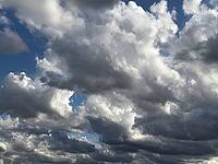 Large cloud field dense cloud cover large wind-driven white cluster clouds Cumulus Stratocumulus with gray underside under blue sky, Germany [IBR125414245]