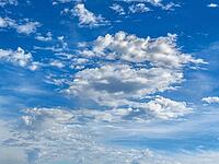 White cluster clouds Cumulus in various shapes above small altocumulus middle cumulus below back Stratocumulus under blue sky, Germany [IBR125414248]