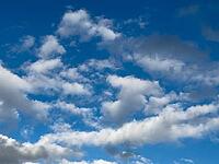White cluster clouds Cumulus in various forms Altocumulus Stratocumulus under blue sky, Germany [IBR125414251]