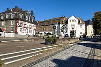 View of over Goetheplatz with old historic residential building half-timbered house in the background in the background 16th century gate house of Berleburg Palace facing the city side, Bad Berleburg, North Rhine-Westphalia, Germany [IBR125414254]