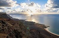 Steep cliffs on the coast with sea, Mirador del Porrito viewpoint at sunset, Lanzarote, Canary Islands, Spain [IBR125414262]