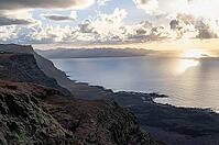 Steep cliffs on the coast with sea, Mirador del Porrito viewpoint at sunset, Lanzarote, Canary Islands, Spain [IBR125414263]