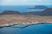View of the sea and the island of La Graciosa with the village of Caleta de Sebo, at sunset, Lanzarote, Canary Islands, Spain [IBR125414266]
