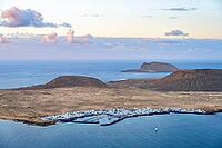 View of the sea and the island of La Graciosa with the village of Caleta de Sebo, at sunset, Lanzarote, Canary Islands, Spain [IBR125414269]