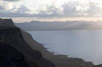 Steep cliffs on the coast with sea, Mirador del Porrito viewpoint at sunset, Lanzarote, Canary Islands, Spain [IBR125414273]