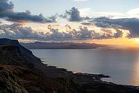 Steep cliffs on the coast with sea, Mirador del Porrito viewpoint at sunset, Lanzarote, Canary Islands, Spain [IBR125414274]