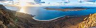 View of steep cliffs to sea and the island of La Graciosa, Mirador del Porrito viewpoint at sunset, Lanzarote, Canary Islands, Spain [IBR125414285]