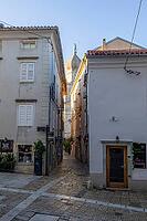 Narrow alley in the old town, in the back the cathedral tower, Krk, Krk island, Croatia [IBR125415364]