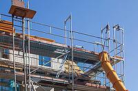 Scaffolding with downpipe and dumpster during construction work to renovate an old building, Bremen, Germany [IBR125415382]
